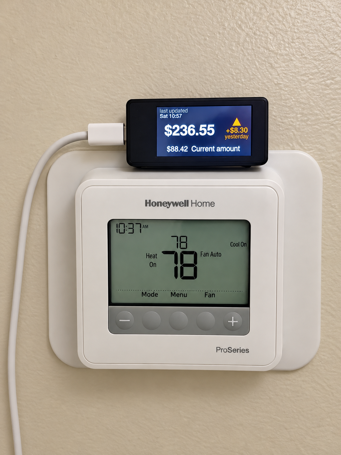 ESP32 display showing live SCE electricity price mounted above a home thermostat
